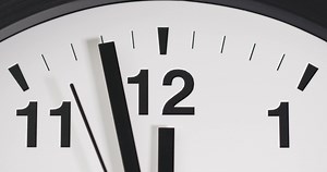 Download Close-up clock face at 12 o'clock with a second hand moving. for free