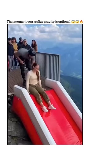 Creative Zack on Instagram: "The post shares a 10-second video of a woman and instructor sliding down a red inflatable ramp on a Swiss Alps cliff, plummeting 100 feet into a blue suspended airbag that rebounds them skyward, garnering 182 Indonesian replies expressing terror and doubt about its authenticity. This setup is a bigairbag® attraction, engineered for year-round extreme sports in alpine valleys like those near Interlaken, Switzerland, where participants reach speeds up to 50 km/h before