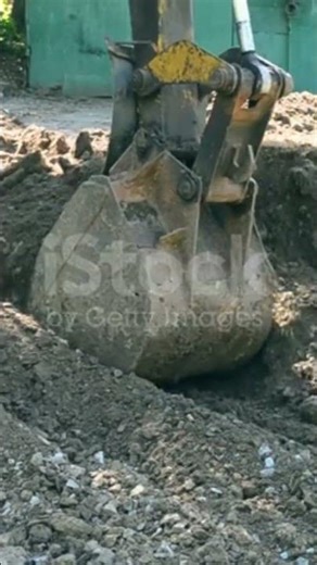 Scene slow motion of excavator bucket digging into 