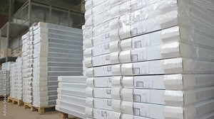 Finished goods warehouse in the factory. Industrial warehouse. Packaged goods and materials spread out on the floor in a warehouse.