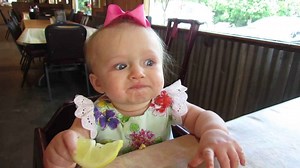 Adorable moment baby eats lemon for the first time