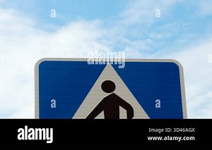 Pedestrian Crossing sign with a blue background, featuring a pictogram of a person walking across zebra stripes