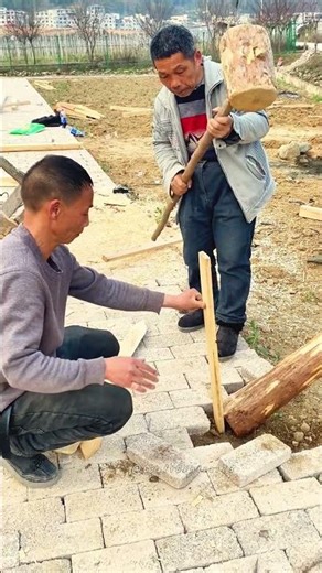 Manual Paving and Timber Post Installation in Rural Setting