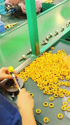 Efficient Factory Worker Assembling Small Yellow Parts with Precision