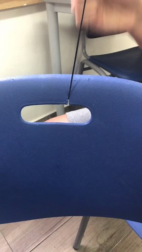 Threading String Through a Plastic Chair: A Close-Up