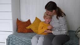 Crying, sad and tears of 6 years old boy with mom for comfort, safety...