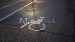 Parking for all: Handicapped or disabled sign displayed on the asphalt, designating an inclusive parking area