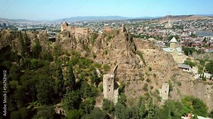 Narikala ancient fortress overlooking Tbilisi, capital of Georgia. famous tourist attraction in Tbilisi Old Town. Summer travel in Georgia, tourism destination.