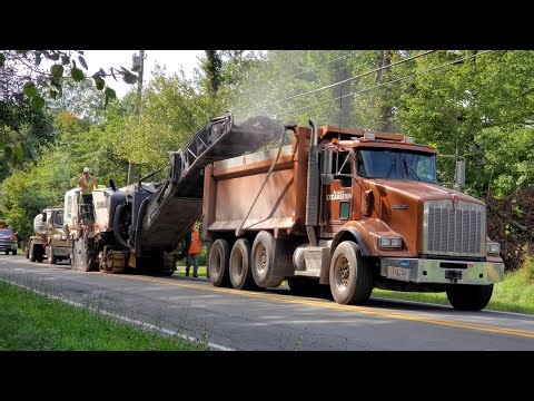 Road Paving from Start to Finish. Diesel Powered Heavy Equipment. Asphalt Paver Road Scraper Dump Tr