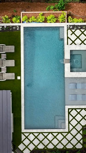 Transform your outdoor space with timeless design. ✨ This backyard comes to life with @nptpoolproducts — from striking finish to elegant tile and hardscapes. NPT provides the design elements and inspiration to create outdoor spaces you’ll love. 💧 #POOL #NPTPool #OutdoorLiving | SwimmingPool.com