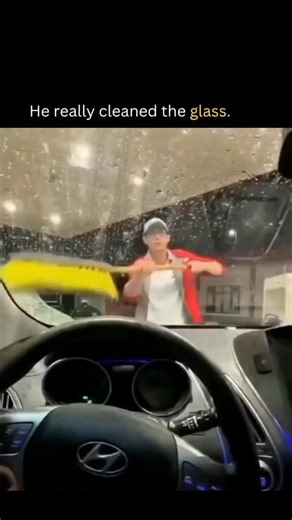 wahid on Instagram: "The video captures a nighttime POV from inside a Hyundai car, showing a cleaner in a red shirt and white apron methodically squeegeeing a foggy, rain-streaked windshield with a yellow tool, achieving streak-free clarity through overlapping vertical and horizontal wipes. Posted by @anneindriani_ On October 6, 2025, it quickly amassed 1.9 million views and 2,600 likes, highlighting viral appeal of mundane excellence in service work. Replies predominantly speculate on Al genera