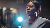 Close-up footage of beautiful black woman running on treadmill in gym