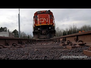 Iron Ore Pellets Flying Under CN Train Hit Camera and Knock it Over!!