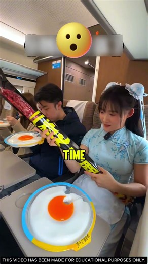 The girl is eating a huge snack on the train! 🍿🚆