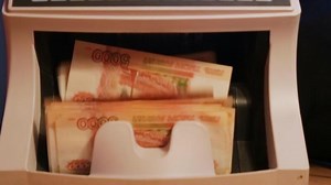 counting banknotes in the Money counting Machine. Machine for counting money with Russian money