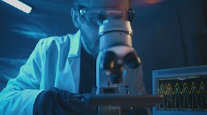 Scientist looking into a microscope - Free Stock Video