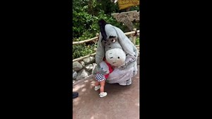 Baby shares a warm hug with Eeyore at Disneyland Park in California