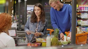 Young couple laying out goods at the check out in a supermarket Free Stock Video Footage
