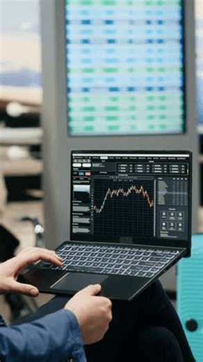clip-4140539131-vertical-screen-businessman-reviewing-stock-market-graphs