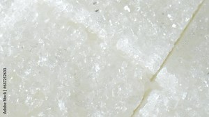 Granulated landscapes in this macro video featuring purified sugar cubes. Witness the mesmerizing textures and intricate dissolution, a sweet journey in every cube.