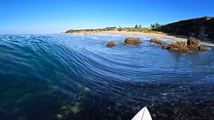 Surfing into rocks at a rare left-hander