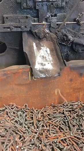 Real Engineerings | Engineering & Technology & Gadgets & DIY on Instagram: "​A high-speed automated stirrup bender in action. ⚙️ ​This machine is a marvel of kinematics, converting the rotational motion of its motor into a perfectly synchronized sequence of actions: ​Feed: A straight rebar is fed into the work area. ​Bend: A powerful mechanical actuator cold-forms the bar around a central die. ​Shear: The finished "U" shape is cut from the stock. ​This high-volume automation is essential for the