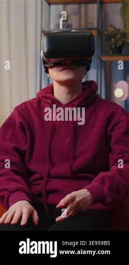 Woman using virtual reality futuristic technology VR app headset helmet play simulation 3D 360 video game watching film movie at home apartment. Girl in goggles sitting on sofa. Transition zoom effect Stock Video Footage - Alamy