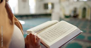 Muslim person, hands and reading with quran at mosque for god worship, knowledge or words of Allah. Closeup of islamic scripture, religious or holy book for information or arabic literature at temple