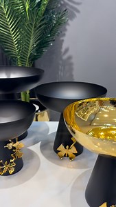Bring a touch of ultra-luxury to your space with this Black & Gold Decorative Pedestal Bowl Set. Featuring a rich metallic gold finish with a modern matte black base and elegant leaf detailing, these bowls are perfect for styling coffee tables, consoles, dining spaces, and vanity corners. A premium statement piece for modern homes that love classy décor. | Dynasty Home