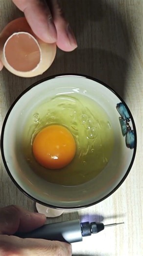 Artistic Engraving Pen in Action: Carving an Olive Branch on an Eggshell