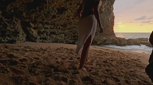 Woman in white dress runs and spins on the beach - Free Stock Video