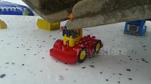 Construction worker builds lego using an excavator