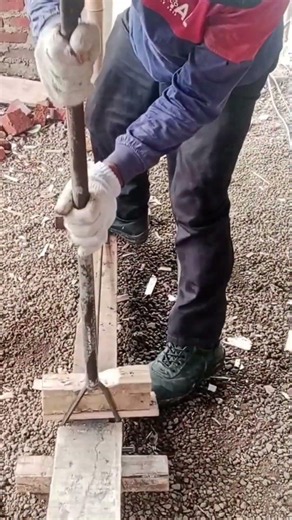 A construction worker is bending 12 mm reinforced concrete.