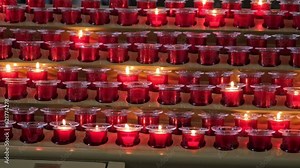 Rows of Wax Prayer Candles Lit in Christian Church Burning on Metal Stand in Christian Church during Catholic Holy Mass