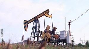 Industrial oil production industry, derrick pumps oil outdoors in the field on the oil platform. The concept of the economy, production and extraction of oil, environmental pollution, fuel, petroleum