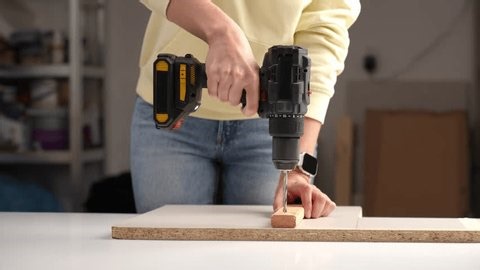 clip-3997408949-close-person-using-electric-drill-drive-screw