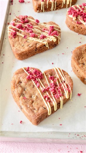 Celebrate Valentine’s Day with these easy chocolate chip cookie hearts. Wrap a heart shaped cookie cutter with a square of heavy duty foil. I used a 3” cutter, removed the cutter and lightly sprayed inside with baking spray. I filled the form with about 3 tablespoons of cookie dough. Bake and cool before unwrapping the foil and finishing. These DIY heart baking molds also work great for brownie and blondie batter. After cooling they can be drizzled with melted chocolate or decorated with butterc
