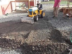 Granpa teaching grandkids to move dirt with a cub cadet 123