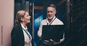 Server room, man and woman or laptop with teamwork, communication and information technology. Datacenter, employees and collaboration with happiness to store and power computer hardware on the system