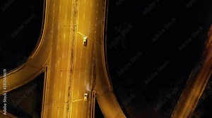 Highway cloverleaf interchange intersection (junction) with ramps, heavy traffic, aerial hyperlapse. A cloverleaf typical two-level, four-way interchange.