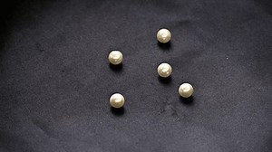 White Pearls Falling On Black Cloth Stock Footage Video (100% Royalty-free) 3533563743 | Shutterstock