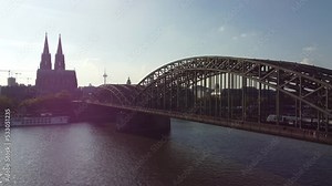 train drive on bridge and arrive at train station in Cologne next to cathedral from above with famous cologne view from rhine river side with Hohenzollern bridge in front