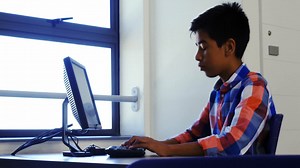 Schoolboy studying on computer in classroom | Premium Stock Video Footage