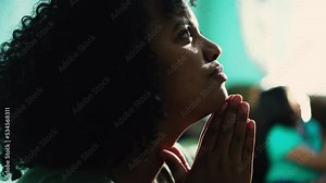 African American woman praying to God. A spiritual black hispanic girl in prayer having HOPE and FAITH