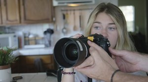 clip-1033589759-teenager-girl-learning-use-camera-blue-eyes