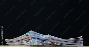 4K Stop of motion stack overload document report paper with paperclip place increase, business and education concept footage paperless used.