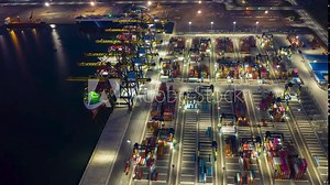 Aerial Hyperlapse Time lapse. Container ships in the harbor with bridges Crane Operates export and import business at sea at night. Logistics and transportation