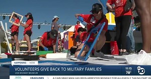 Volunteers build furniture for military families aboard the USS Midway