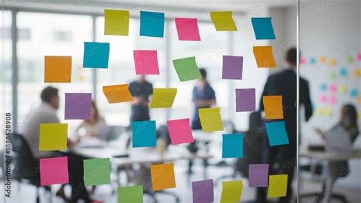 Colorful sticky note planning board glass modern office with blurred team brainstorming, collaboration, teamwork, and creative workflow planning