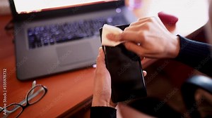 Woman Hands Cleaning and Disinfecting With Cloth Her Phone